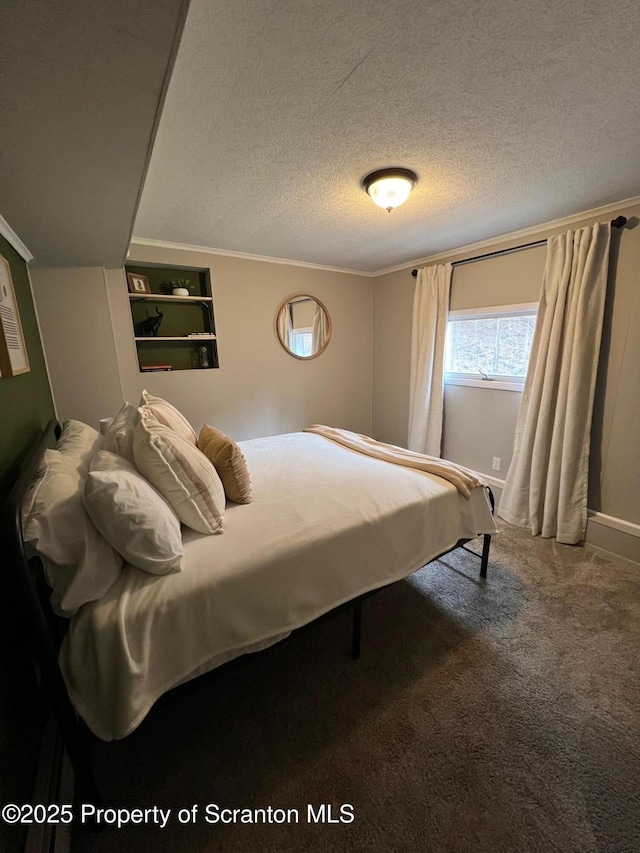 bedroom featuring ornamental molding, carpet flooring, and a textured ceiling