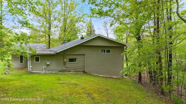 rear view of property featuring a lawn