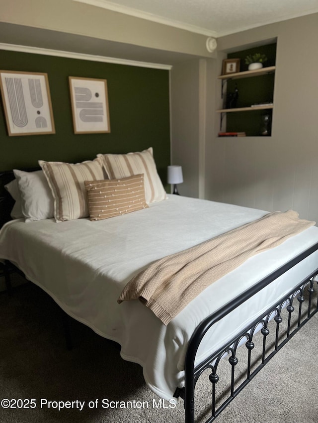 bedroom featuring ornamental molding and carpet floors