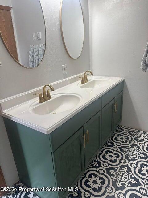 bathroom with tile patterned floors and vanity