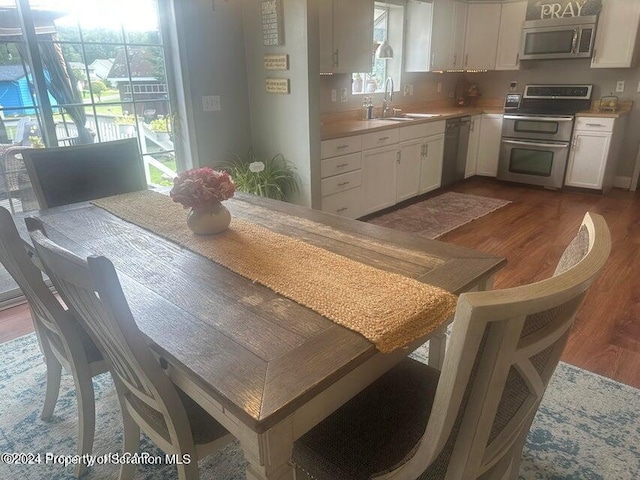 kitchen with sink, white cabinets, a healthy amount of sunlight, and appliances with stainless steel finishes