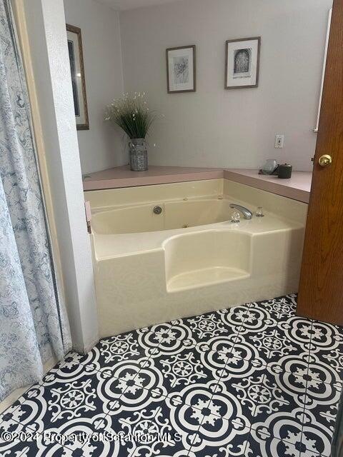 bathroom featuring tile patterned floors and a tub