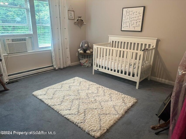 carpeted bedroom with cooling unit, a baseboard radiator, and a crib