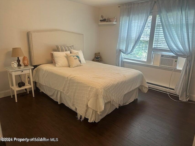 bedroom with baseboard heating, cooling unit, and dark wood-type flooring