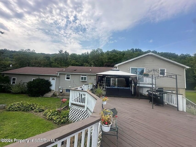 wooden deck with a gazebo and grilling area