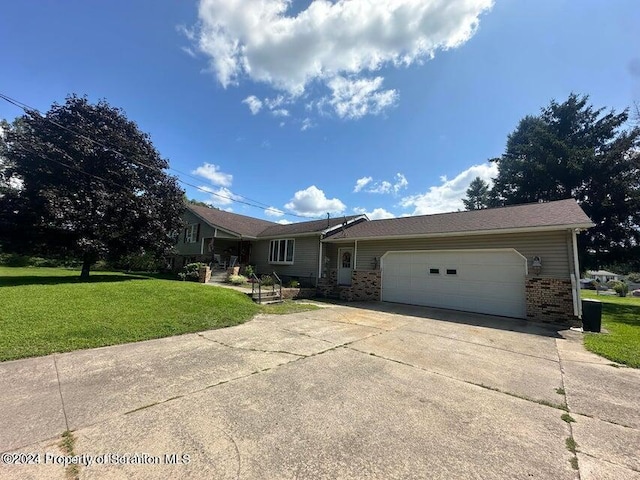 single story home featuring a garage and a front yard