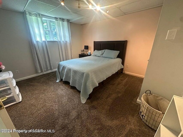 carpeted bedroom featuring a paneled ceiling