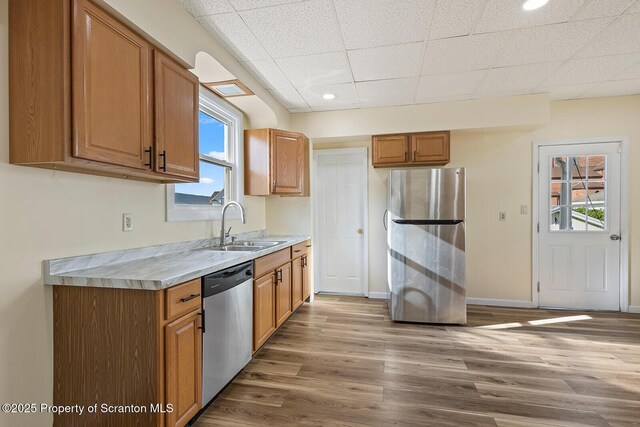 1324 Dartmouth St, Scranton, PA 18504 - kitchen with appliances with stainless steel finishes, light countertops, plenty of natural light, light wood-type flooring, and a drop ceiling