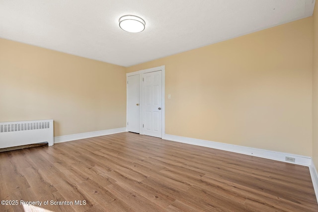 1324 Dartmouth St, Scranton, PA 18504 - empty room with radiator and wood finished floors