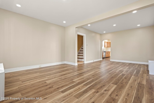1324 Dartmouth St, Scranton, PA 18504 - unfurnished living room featuring arched walkways, light wood-style floors, stairway, and recessed lighting