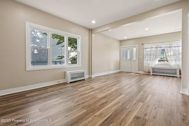 1324 Dartmouth St, Scranton, PA 18504 - unfurnished living room with wood finished floors, recessed lighting, and heating unit