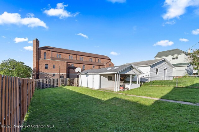 1324 Dartmouth St, Scranton, PA 18504 - rear view of house featuring a fenced backyard and a chimney