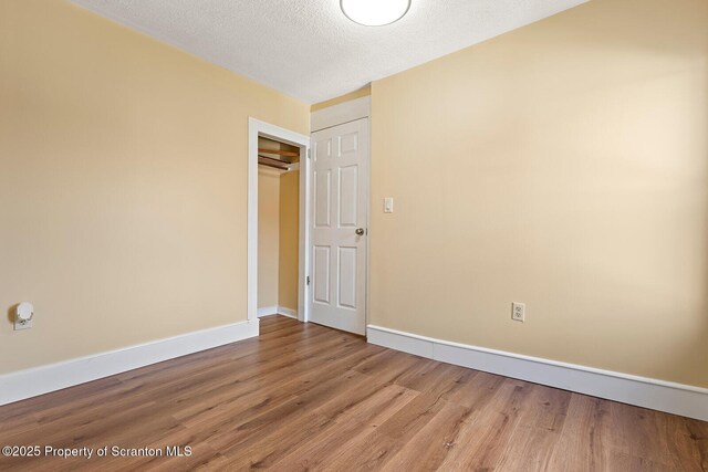 1324 Dartmouth St, Scranton, PA 18504 - unfurnished bedroom featuring wood finished floors, a textured ceiling, and a closet