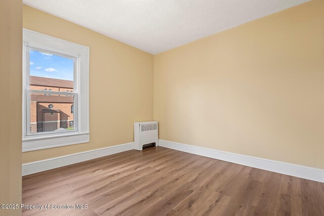 1324 Dartmouth St, Scranton, PA 18504 - unfurnished room with radiator heating unit and wood finished floors