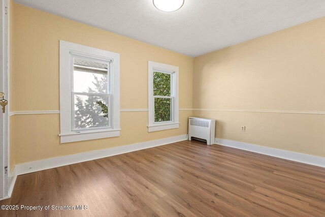 1324 Dartmouth St, Scranton, PA 18504 - unfurnished room with radiator heating unit and wood finished floors