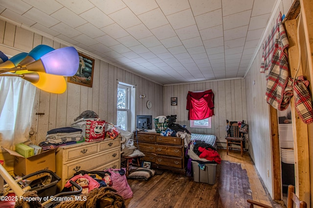 bedroom with crown molding and dark wood-type flooring