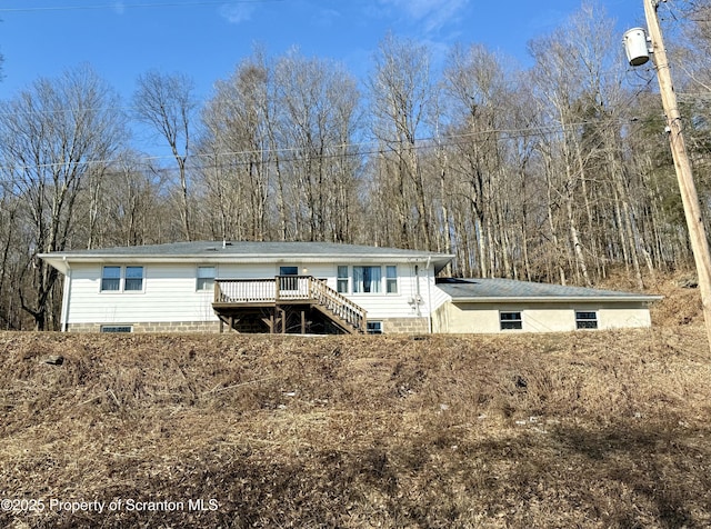 rear view of house with a deck and stairway