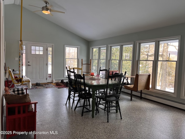 dining area with ceiling fan, high vaulted ceiling, and a baseboard heating unit