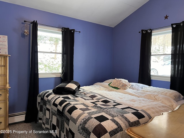 bedroom with a baseboard radiator and vaulted ceiling