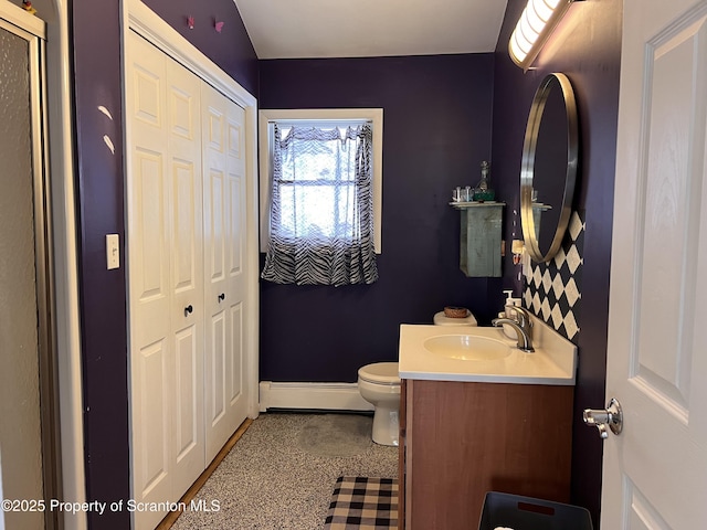 bathroom featuring vanity, toilet, and a baseboard heating unit