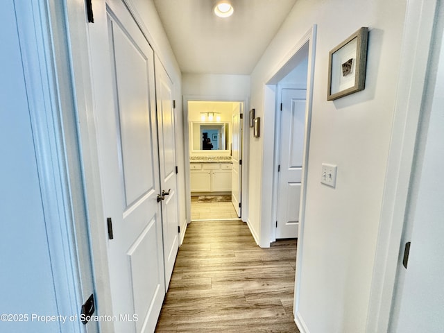 corridor with light hardwood / wood-style flooring