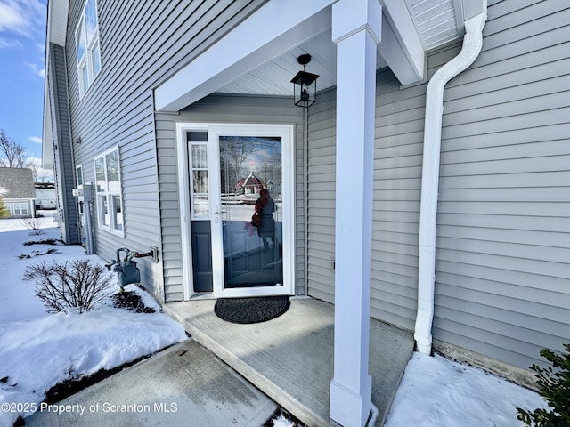 view of snow covered property entrance