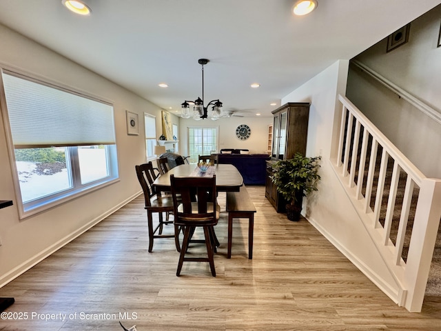 dining area with an inviting chandelier and light wood-type flooring