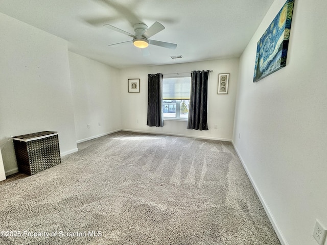 spare room with ceiling fan and carpet