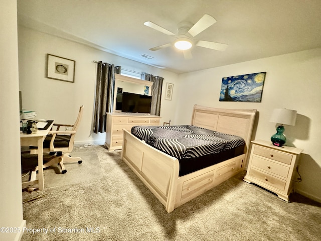 bedroom featuring light colored carpet and ceiling fan