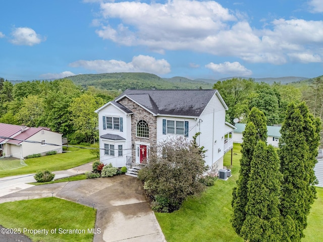 99 Elizabeth Ave, Hallstead, PA 18822 - traditional-style house with central AC, a front yard, a mountain view, and stone siding