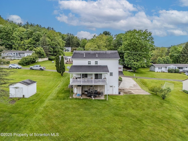 99 Elizabeth Ave, Hallstead, PA 18822 - back of property featuring a patio area, a shingled roof, a deck, and a lawn