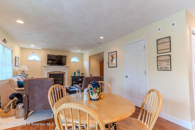 99 Elizabeth Ave, Hallstead, PA 18822 - dining space with a glass covered fireplace, light wood finished floors, recessed lighting, and baseboards