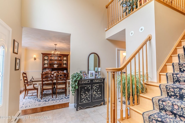 99 Elizabeth Ave, Hallstead, PA 18822 - stairs featuring a towering ceiling, a chandelier, baseboards, and tile patterned floors