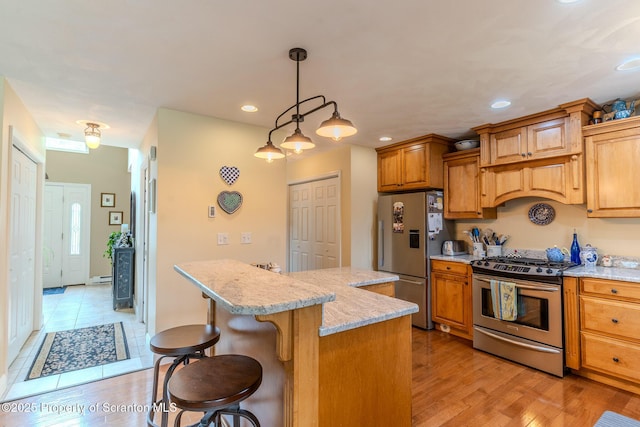 99 Elizabeth Ave, Hallstead, PA 18822 - kitchen with stainless steel appliances, a kitchen breakfast bar, a kitchen island, recessed lighting, and light wood-style floors