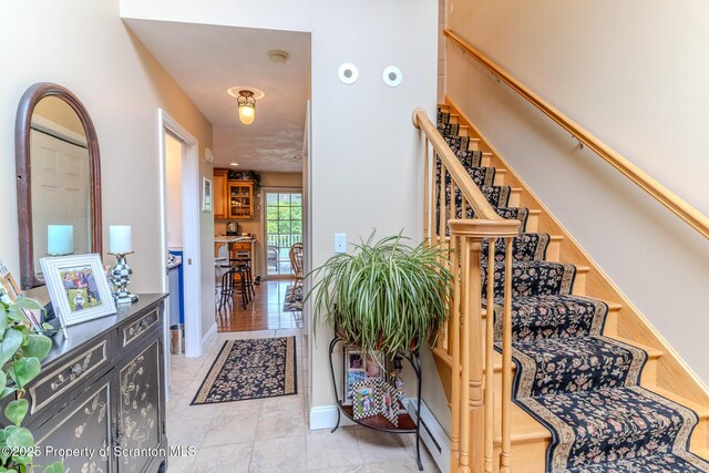 99 Elizabeth Ave, Hallstead, PA 18822 - entrance foyer with stairs, baseboards, and light tile patterned floors