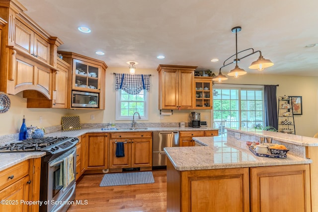 99 Elizabeth Ave, Hallstead, PA 18822 - kitchen featuring appliances with stainless steel finishes, recessed lighting, a sink, glass insert cabinets, and light wood-style floors