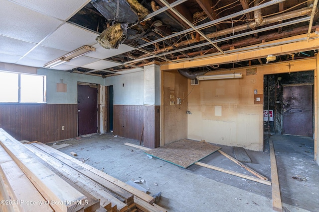 miscellaneous room featuring wood walls