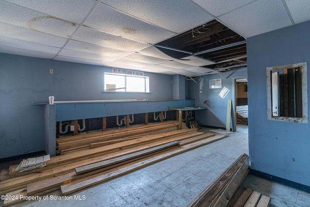 basement featuring a paneled ceiling