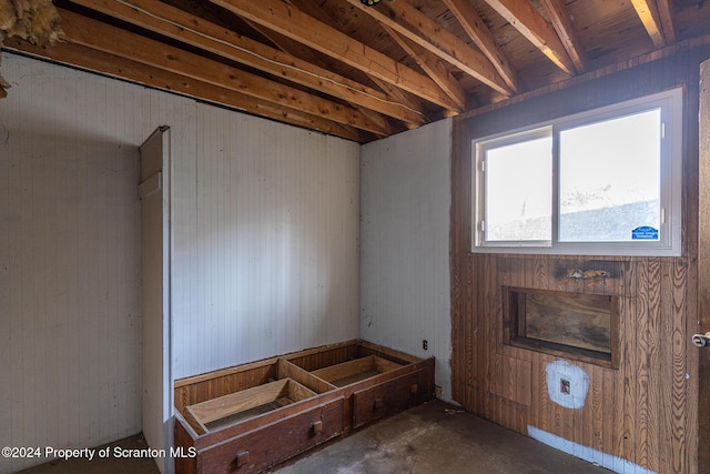 interior space featuring wood walls and concrete flooring