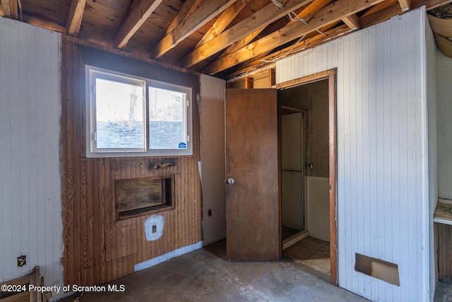 unfurnished bedroom with wooden walls