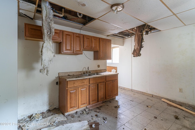 kitchen featuring a paneled ceiling and sink