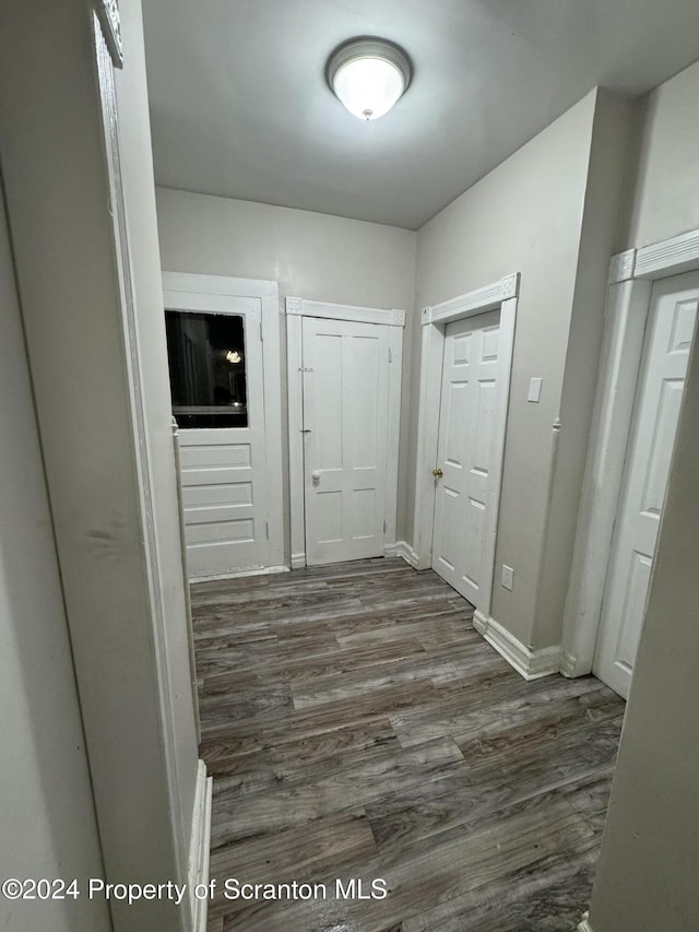 corridor with dark wood-type flooring