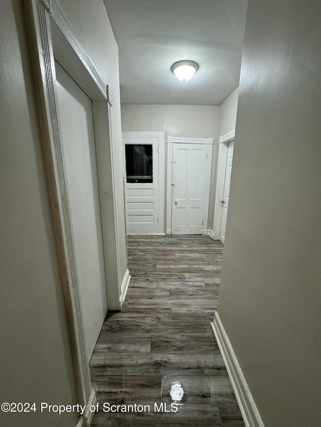 corridor with dark hardwood / wood-style floors