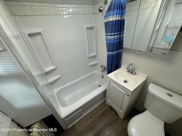 full bathroom with hardwood / wood-style floors, vanity, toilet, and shower / bath combo