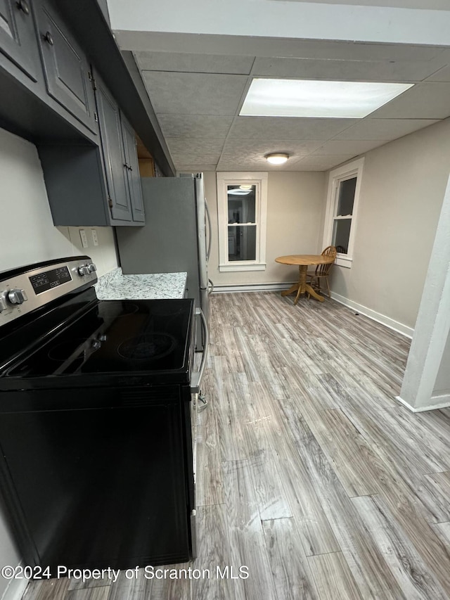 kitchen with light wood-type flooring, black / electric stove, and gray cabinetry