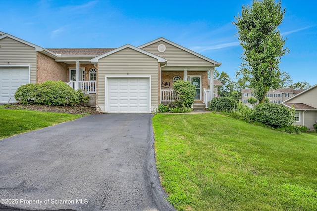 8 Parkland Dr Bldg 9, South Abington Twp, PA 18411 - ranch-style house featuring a porch, an attached garage, a front lawn, brick siding, and asphalt driveway