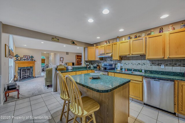 8 Parkland Dr Bldg 9, South Abington Twp, PA 18411 - kitchen featuring light tile patterned flooring, appliances with stainless steel finishes, dark countertops, a breakfast bar, and light carpet