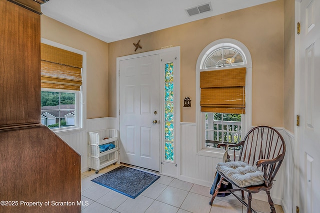 8 Parkland Dr Bldg 9, South Abington Twp, PA 18411 - foyer entrance featuring wainscoting, light tile patterned floors, healthy amount of natural light, and a decorative wall