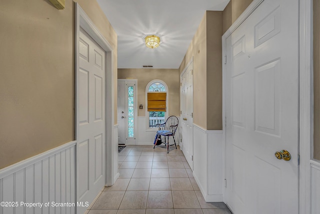 8 Parkland Dr Bldg 9, South Abington Twp, PA 18411 - entryway featuring wainscoting, light tile patterned floors, and a decorative wall