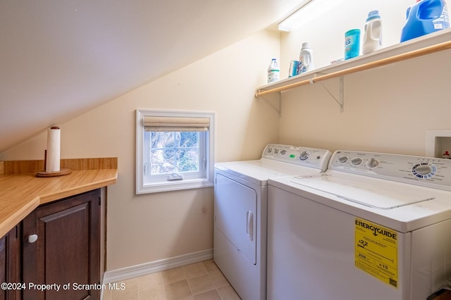 laundry room with cabinet space, baseboards, and independent washer and dryer